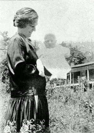 Polly with flowers in her hair and a smile on her beautiful face, she's holding her firstborn, my Aunt Renie. I'm guessing she's 17 at the time and the year is around 1924. 